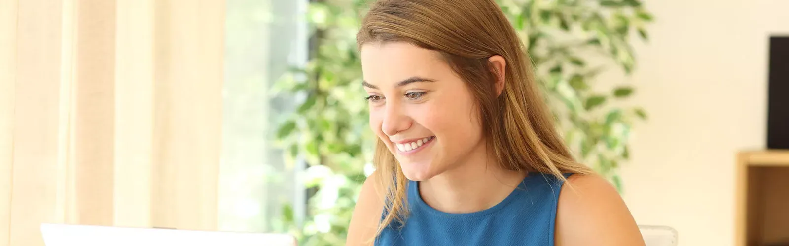 girl smiling in front of window